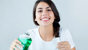 happy-young-woman-using-mouthwash.webp.webp